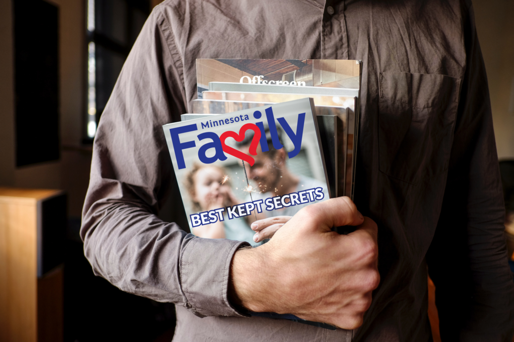 Minnesota Family magazine artwork stack held in an arm